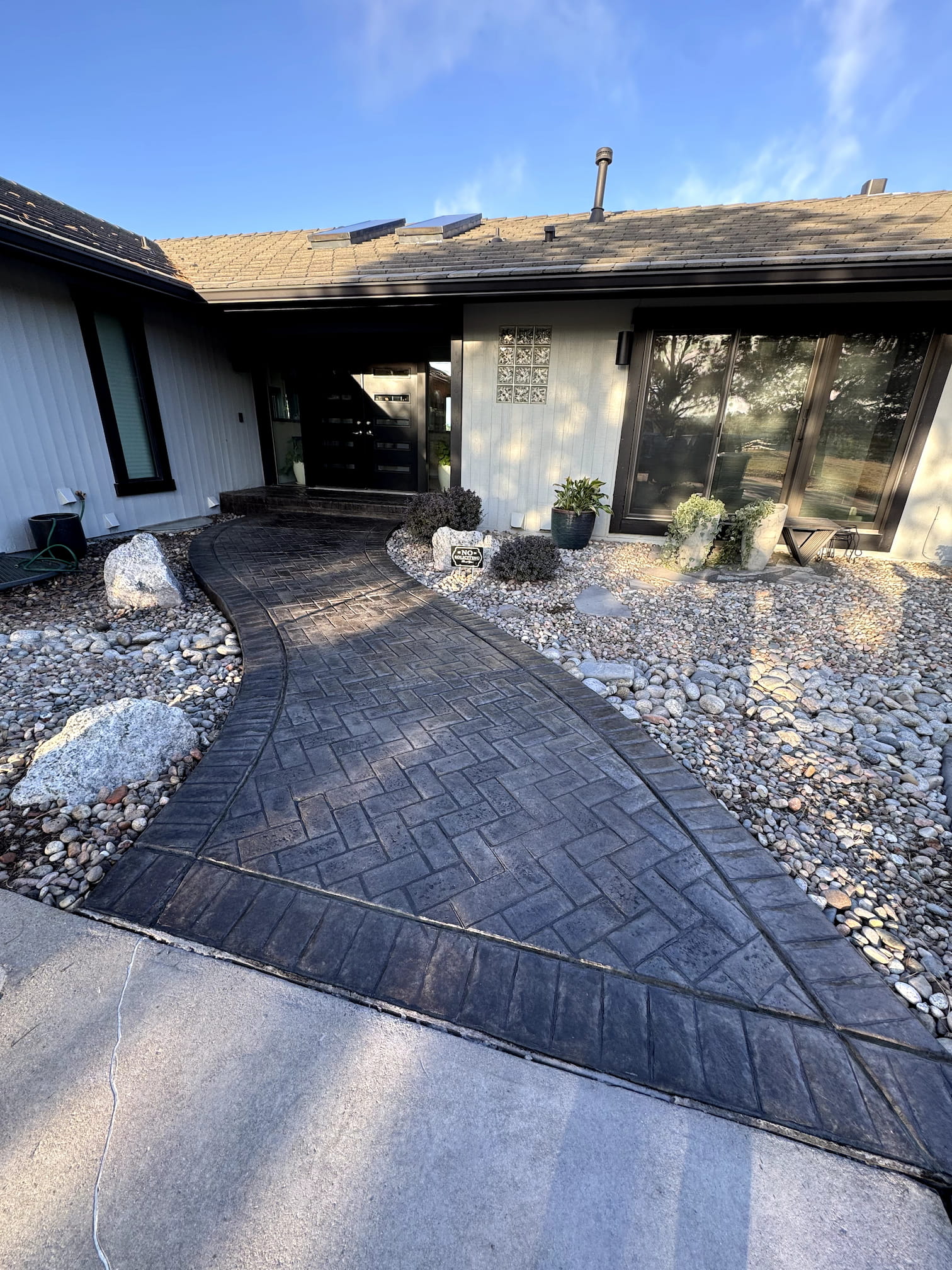 Natural stone paver pool deck installation showcasing high-end textures and earth tones in Centennial.